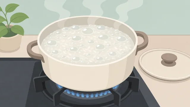 An uncovered pot of rice and water at a rolling boil on a stove