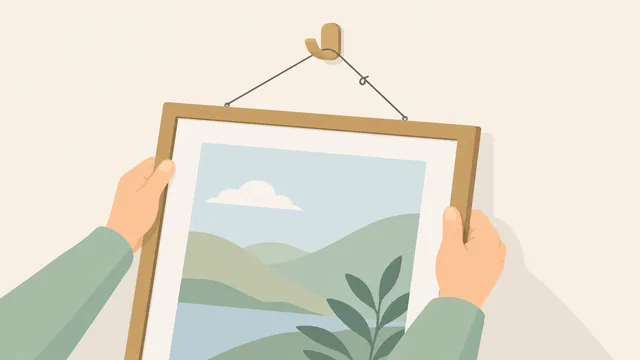 A person seating a picture frame wire on a wall hook