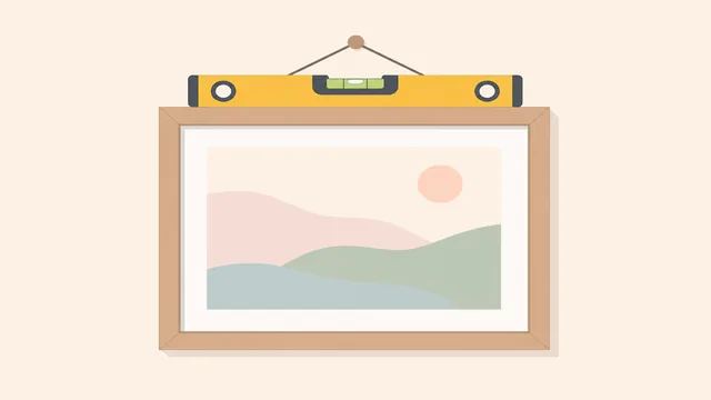 Spirit level resting on the top edge of a picture frame